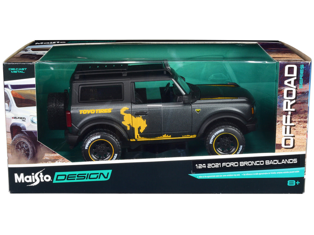 2021 Ford Bronco Badlands Dark Gray Metallic with Gold Graphics and Roof Rack 'Off-Road' 'Maisto Design' Series 1/24 Diecast Model Car by Maisto