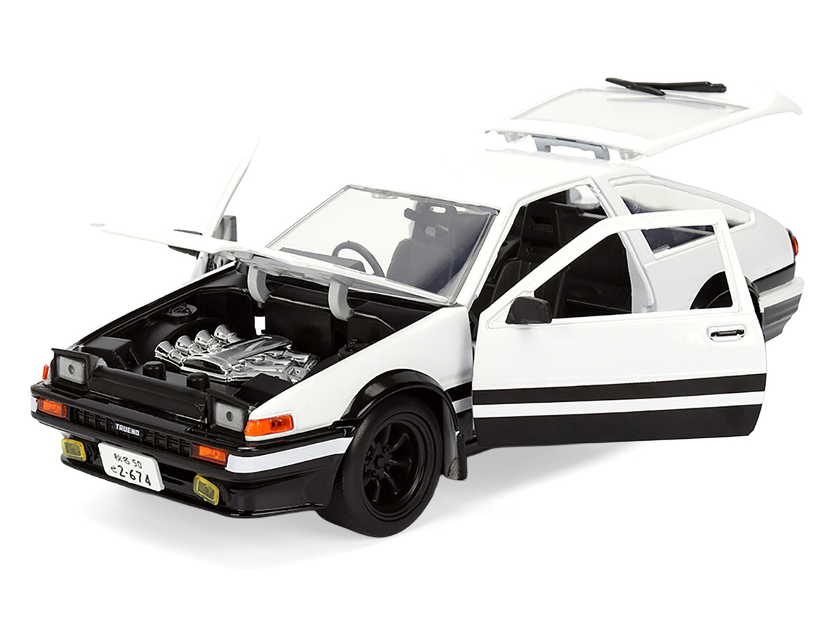 Toyota Trueno (AE86) RHD (Right Hand Drive) White and Black with Graphics and Takumi Diecast Figure 'Initial D' (1998-2021) TV Series 'Anime Hollywood Rides' Series 1/24 Diecast Model by Jada