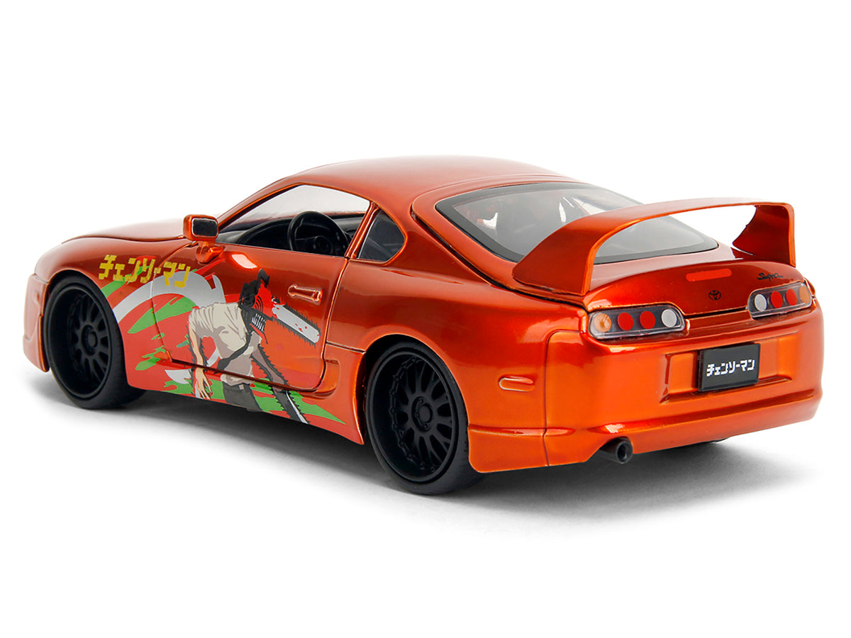 1995 Toyota Supra Orange Metallic with Graphics and Chainsaw Man Diecast Figure 'Chainsaw Man' (2022) TV Series 'Anime Hollywood Rides' Series 1/24 Diecast Model by Jada