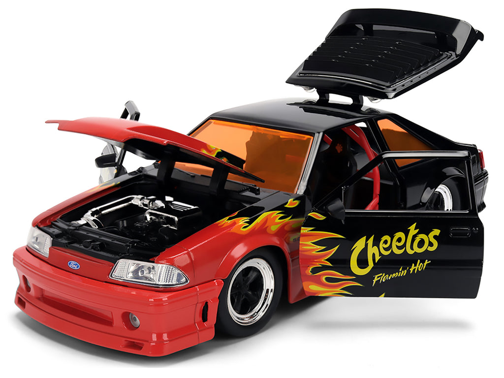 1989 Ford Mustang GT Black with Red Flame Graphics and Chester Cheetah Diecast Figure 'Cheetos Flamin' Hot' 'Hollywood Rides' Series 1/24 Diecast Model Car by Jada