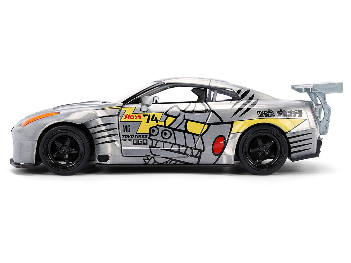 2009 Nissan GT-R (R35) Ben Sopra Brushed Metal with Black Top and Graphics and Mechagodzilla Diecast Figure 'Godzilla' Franchise 'Anime Hollywood Rides' Series 1/24 Diecast Model by Jada