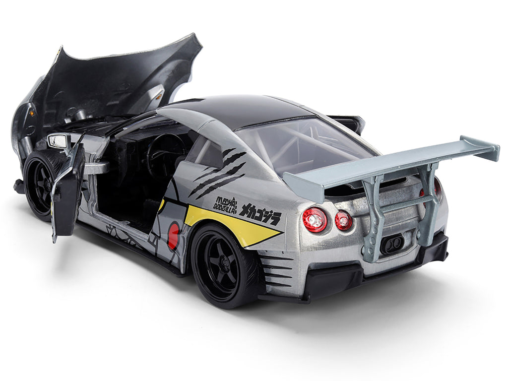 2009 Nissan GT-R (R35) Ben Sopra Brushed Metal with Black Top and Graphics and Mechagodzilla Diecast Figure 'Godzilla' Franchise 'Anime Hollywood Rides' Series 1/24 Diecast Model by Jada