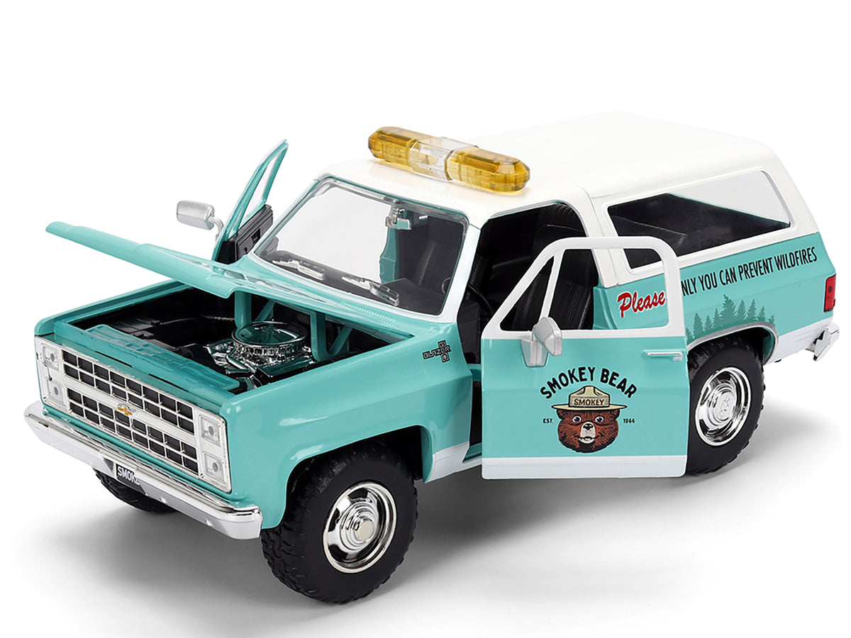 1980 Chevrolet Blazer Light Green with White Top and Graphics and Smokey Bear Diecast Figure 'Smokey Bear' 'Hollywood Rides' Series 1/24 Diecast Model by Jada