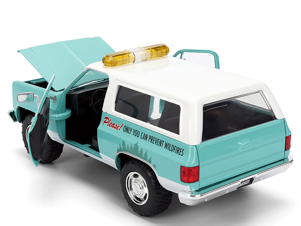1980 Chevrolet Blazer Light Green with White Top and Graphics and Smokey Bear Diecast Figure 'Smokey Bear' 'Hollywood Rides' Series 1/24 Diecast Model by Jada