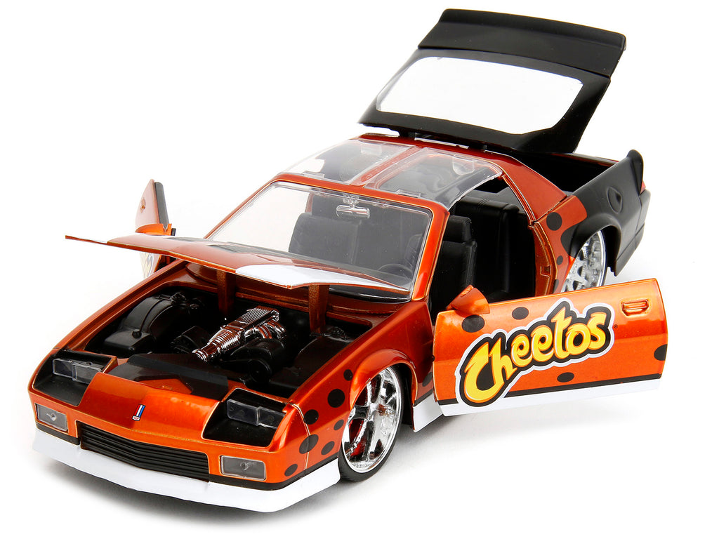 1985 Chevrolet Camaro Z/28 Orange Metallic with Graphics and Chester Cheetah Diecast Figure 'Cheetos' 'Hollywood Rides' Series 1/24 Diecast Model Car by Jada