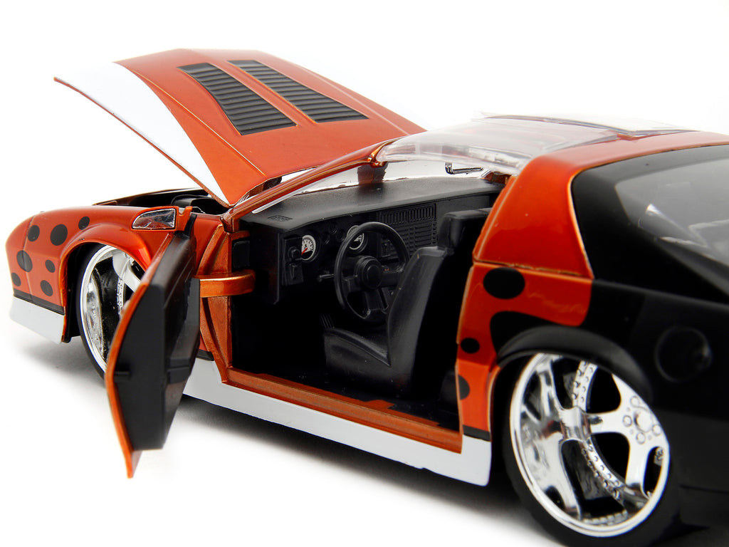 1985 Chevrolet Camaro Z/28 Orange Metallic with Graphics and Chester Cheetah Diecast Figure 'Cheetos' 'Hollywood Rides' Series 1/24 Diecast Model Car by Jada
