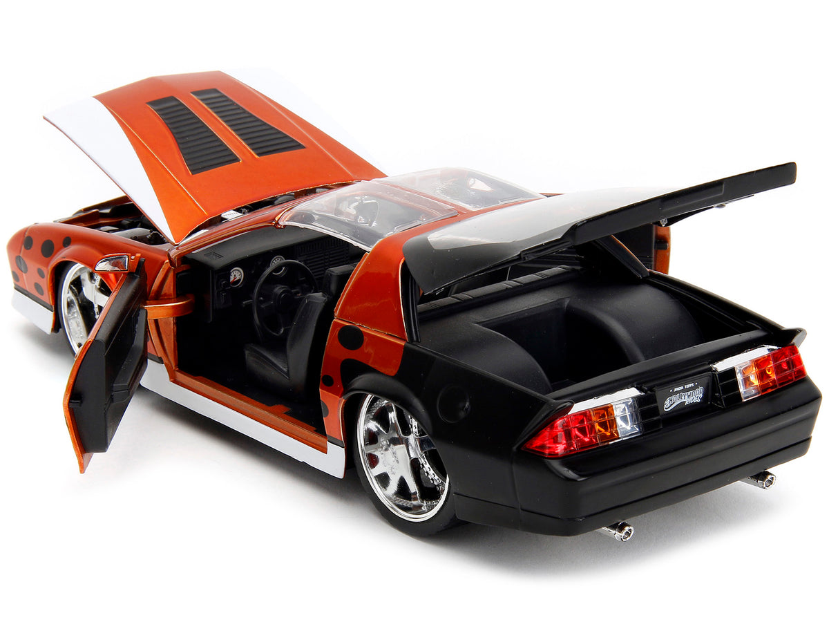 1985 Chevrolet Camaro Z/28 Orange Metallic with Graphics and Chester Cheetah Diecast Figure 'Cheetos' 'Hollywood Rides' Series 1/24 Diecast Model Car by Jada